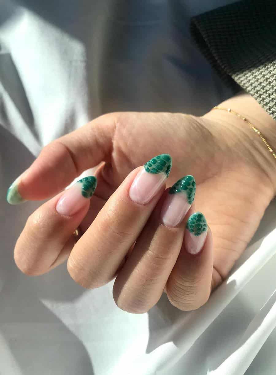 a hand with medium length glossy ɴuᴅᴇ nails with wavy forest green French tips with textured details