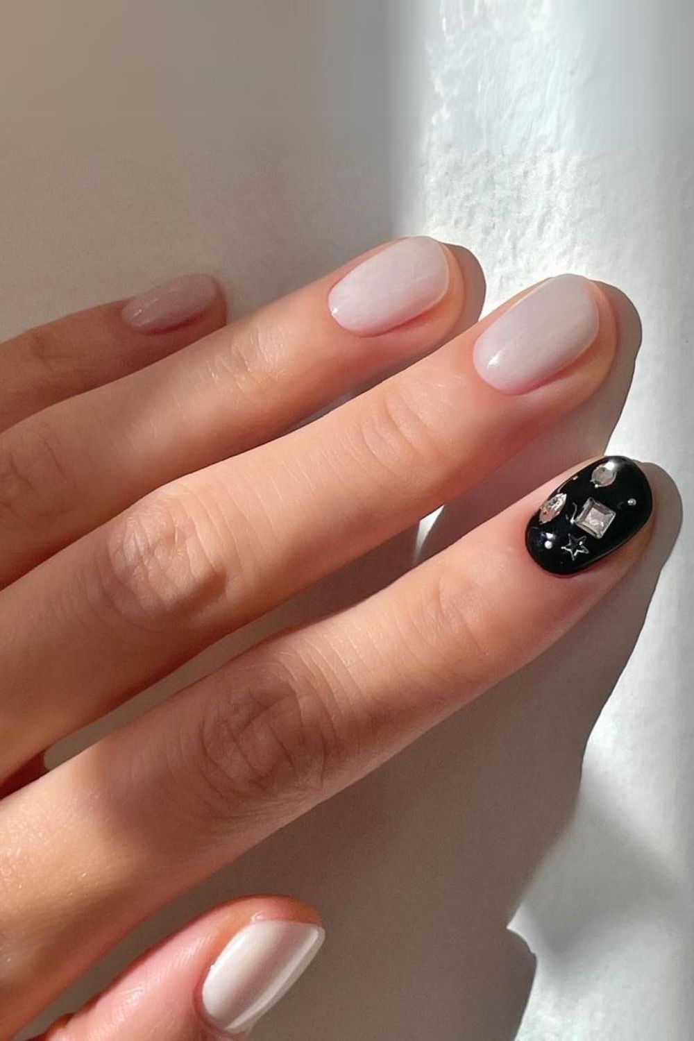 Milky white and black nails with rhinestones