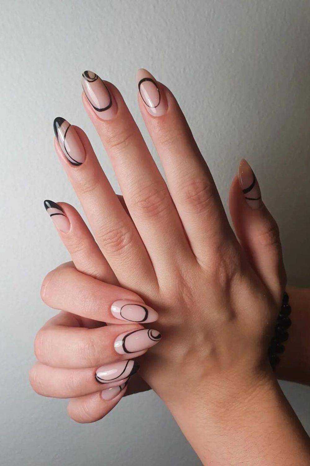 Nude manicure with abstract black lines